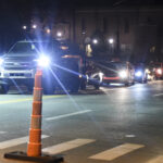 cars with headlights on line up on Beechhurst
